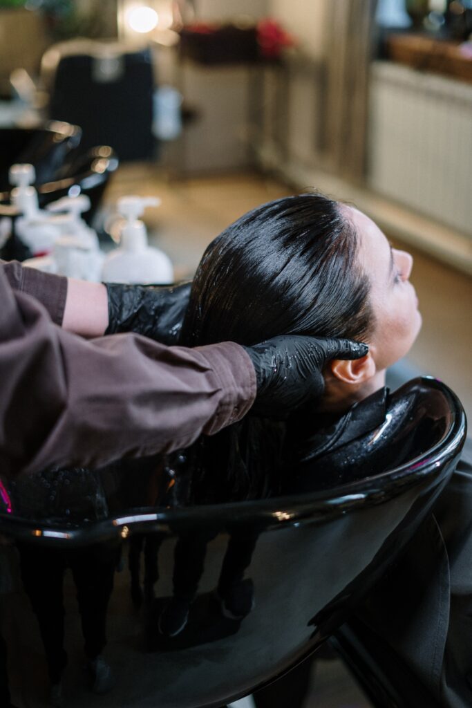 Einer Frau werden die Haare in einem Friseursalon gewaschen.